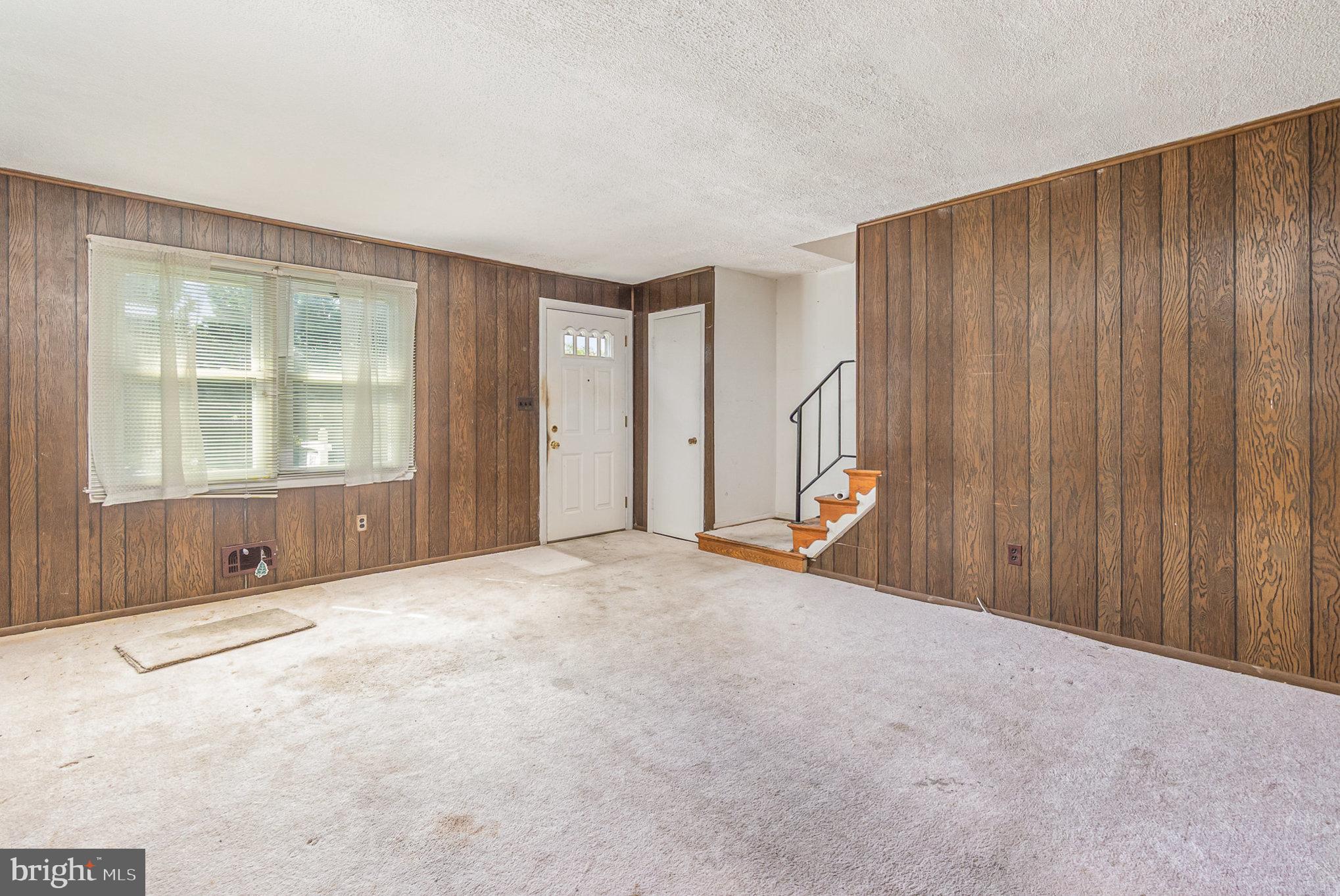 2137 Cockspur Road Baltimore, MD 21220 - Photo 5 of 25 a view of an empty room with wooden floor and staircase