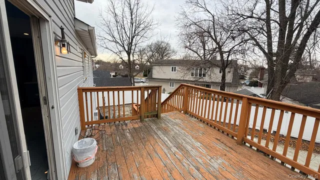 a view of a balcony with wooden floor