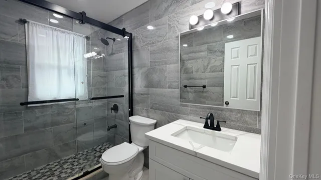 a bathroom with a sink toilet and shower