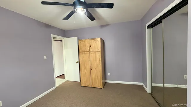 an empty room with chandelier fan