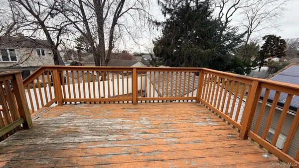 a view of balcony with wooden floor and fence