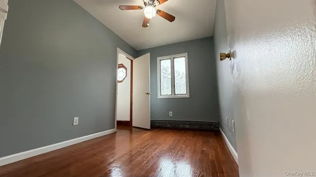 an empty room with closet and windows