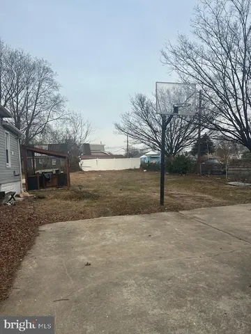 a backyard of a house with large trees