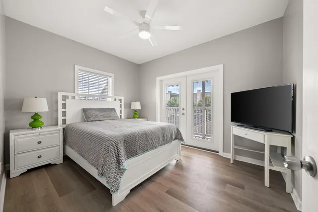 a bedroom with a flat screen tv and a chandelier