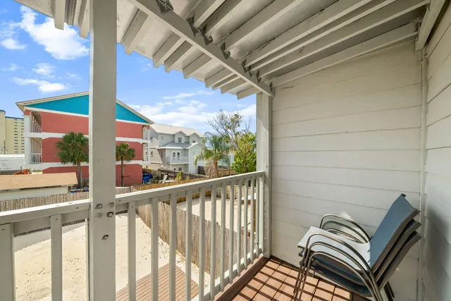 a view of a hallway with wooden floor and entryway