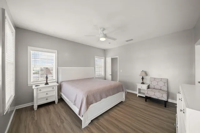 a bathroom with a sink a toilet a mirror and shower