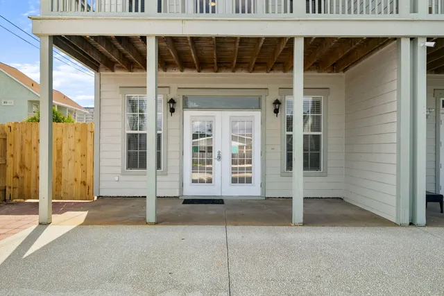 a living room with furniture flat screen tv and a large window