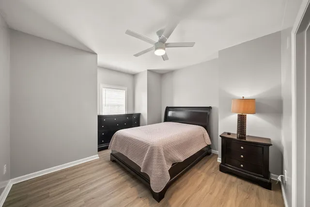 a bedroom with a bed and a lamp