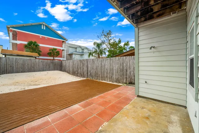 a view of a backyard with a wooden fence
