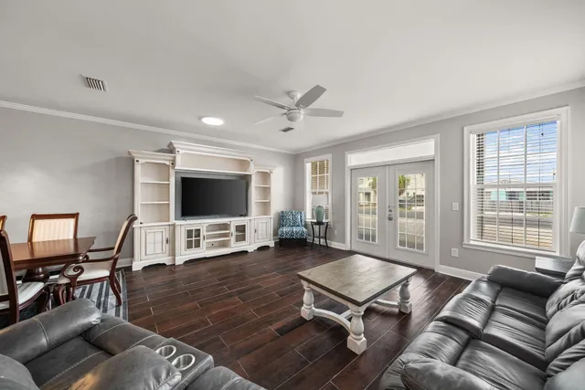 a living room with furniture and wooden floor