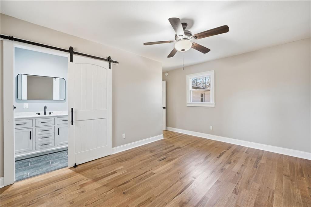 2702 Beecher Drive Austell, GA 30106 - Photo 12 of 27 a view of a livingroom with a ceiling fan and wooden floor