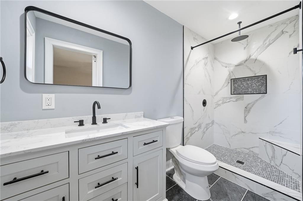 2702 Beecher Drive Austell, GA 30106 - Photo 13 of 27 a bathroom with a granite countertop sink mirror vanity and toilet