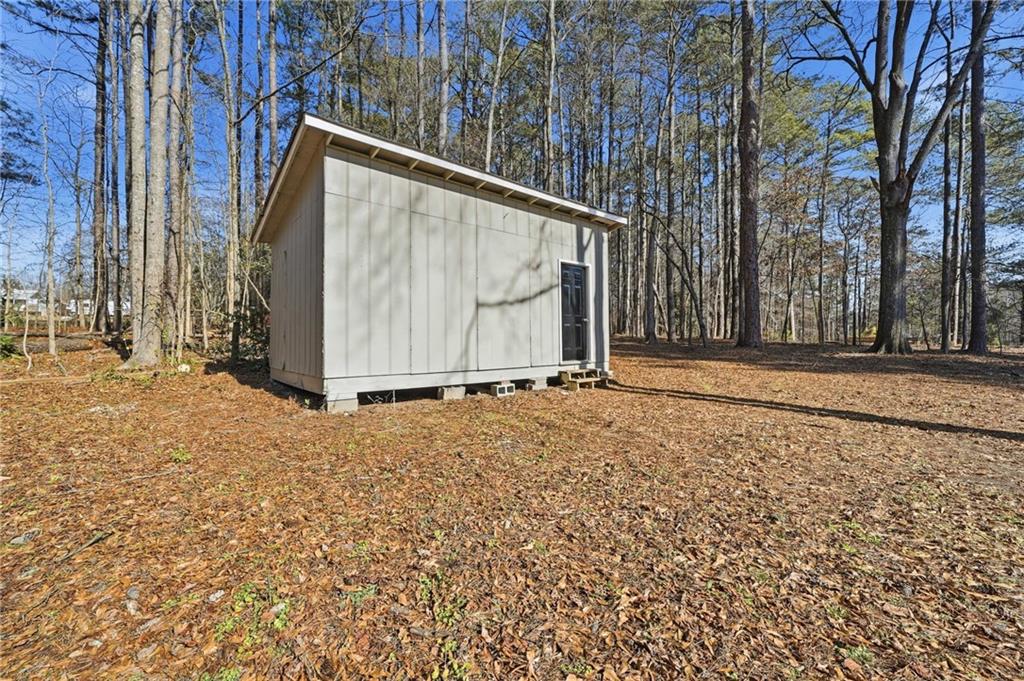 2702 Beecher Drive Austell, GA 30106 - Photo 25 of 27 a backyard of a house with a bench and trees
