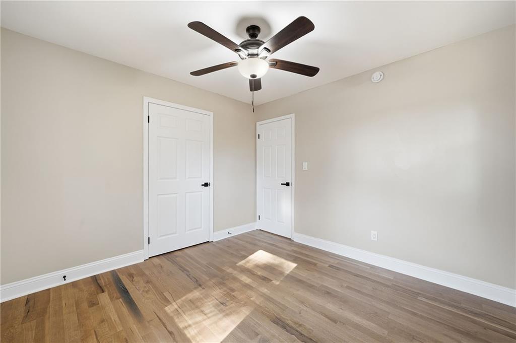 2702 Beecher Drive Austell, GA 30106 - Photo 7 of 27 an empty room with wooden floor and ceiling fan