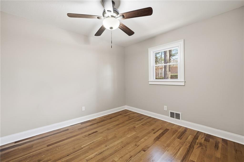 2702 Beecher Drive Austell, GA 30106 - Photo 10 of 27 an empty room with wooden floor and windows