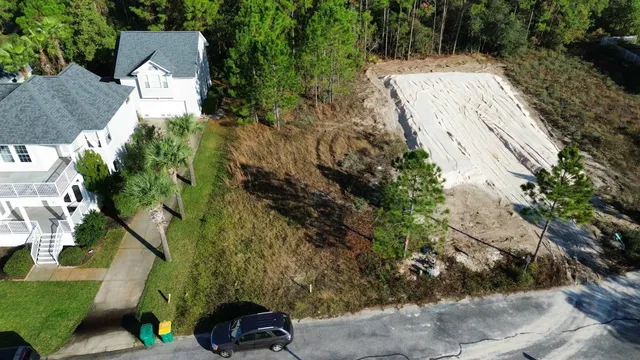 an aerial view of a house with a yard