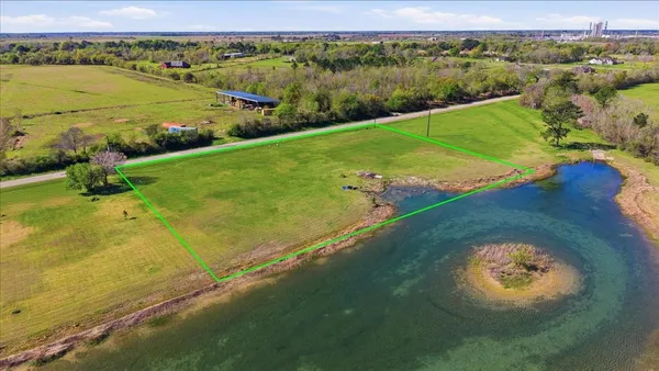 an aerial view of a golf course with a lake view