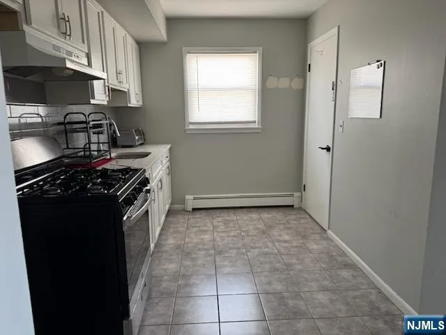 a kitchen with a stove and a refrigerator