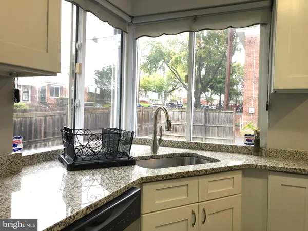 a kitchen with a sink and a large window