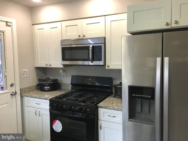 a kitchen with a stove and a refrigerator