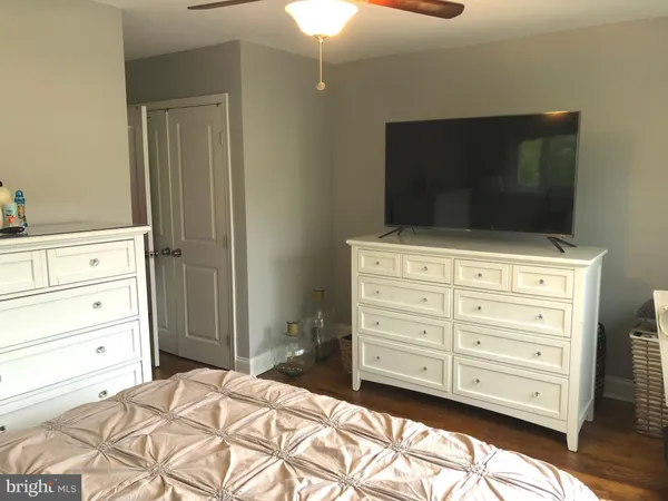 a room with a dresser and a television