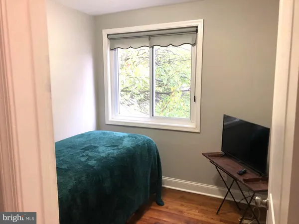 a workspace with a window and a chair