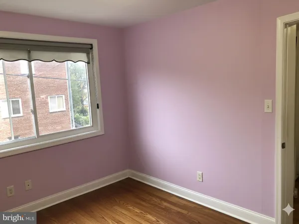 a view of a small space with wooden floor and a window