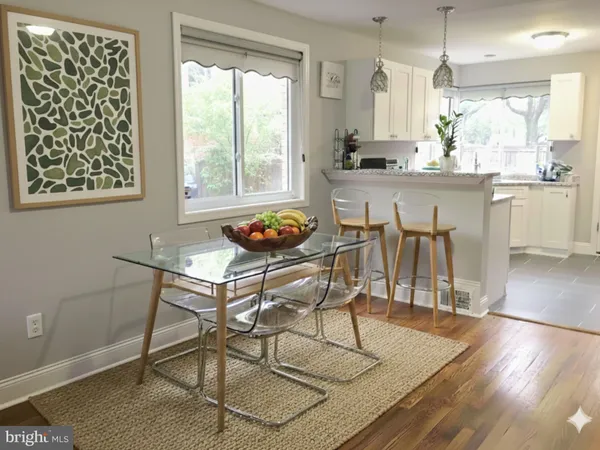 a dining room with furniture and wooden floor