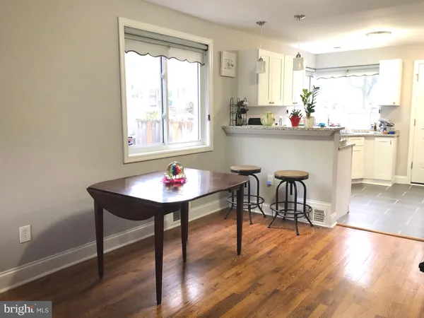 a workspace with wooden floor and a window