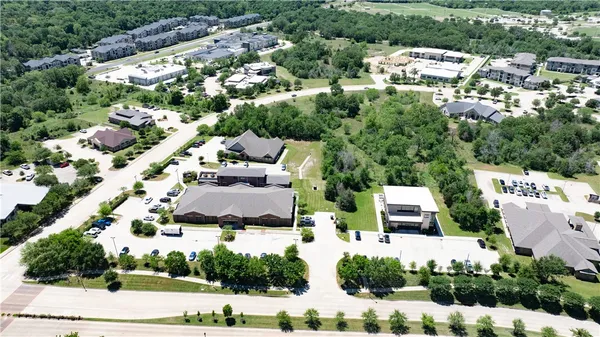 an aerial view of residential houses with city view