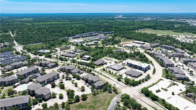 an aerial view of residential houses with outdoor space