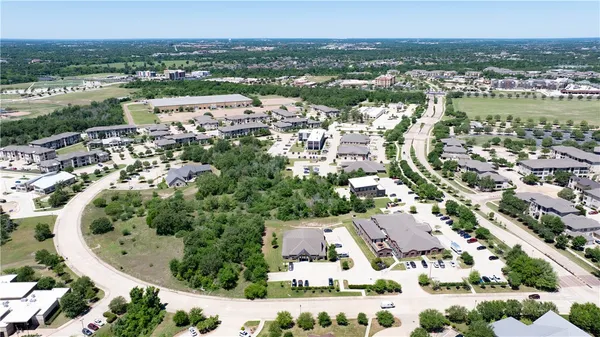 a view of a park with potted plants