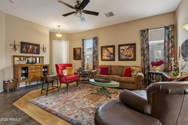 a living room with furniture and wooden floor