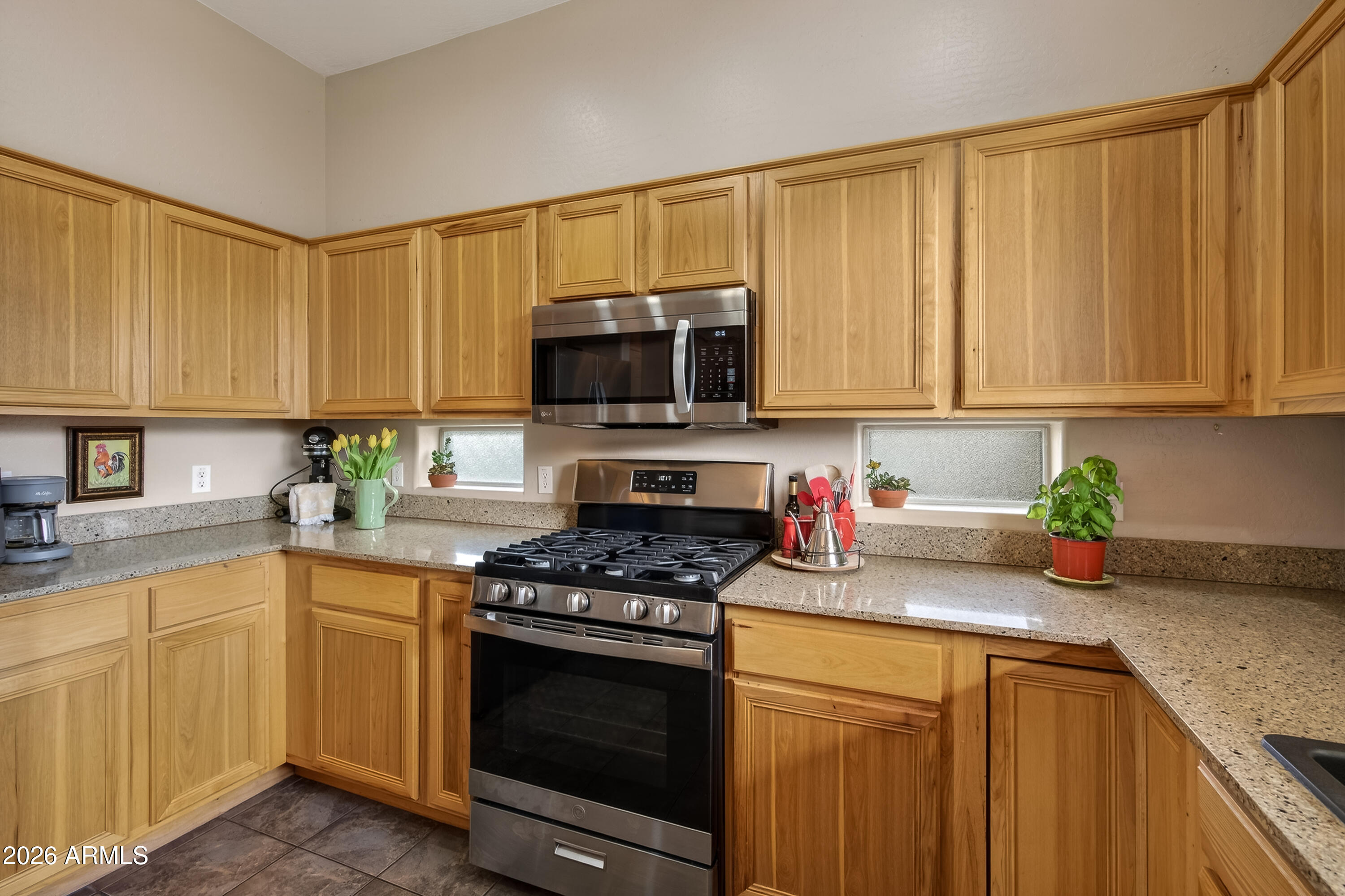 654 South Elk Ridge Drive Camp Verde, AZ 86322 - Photo 16 of 34 a kitchen with stainless steel appliances granite countertop a stove a sink dishwasher and a microwave