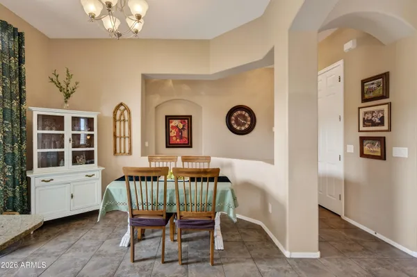 a dining room with a wooden table and chairs
