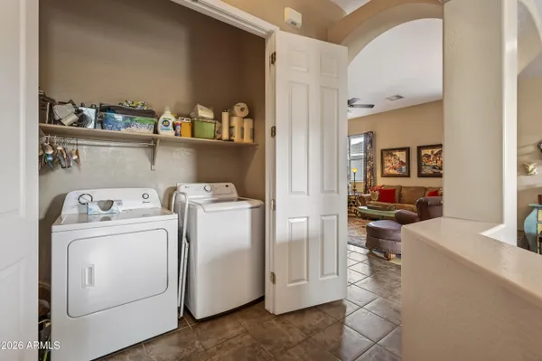 a view of washer and dryer with kitchen in the background