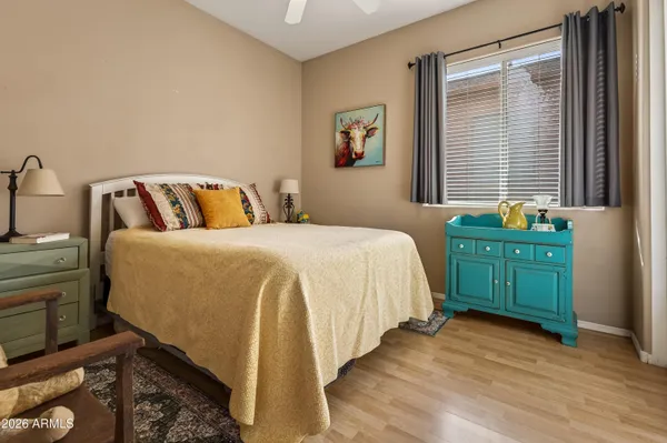 a bedroom with a bed and a window