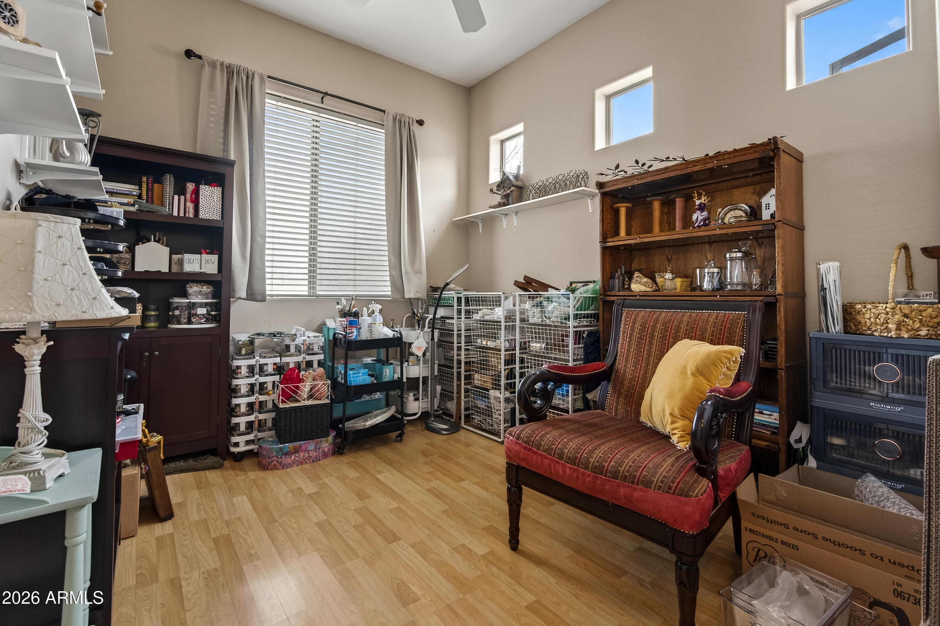 654 South Elk Ridge Drive Camp Verde, AZ 86322 - Photo 27 of 34 a living room with furniture a lamp and a bookshelf