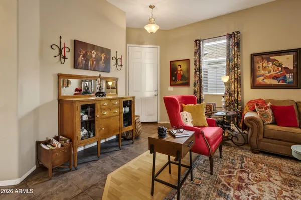 a livingroom with workspace couch and a window