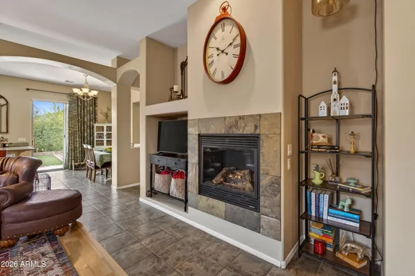 a living room with furniture a bookshelf and a fireplace