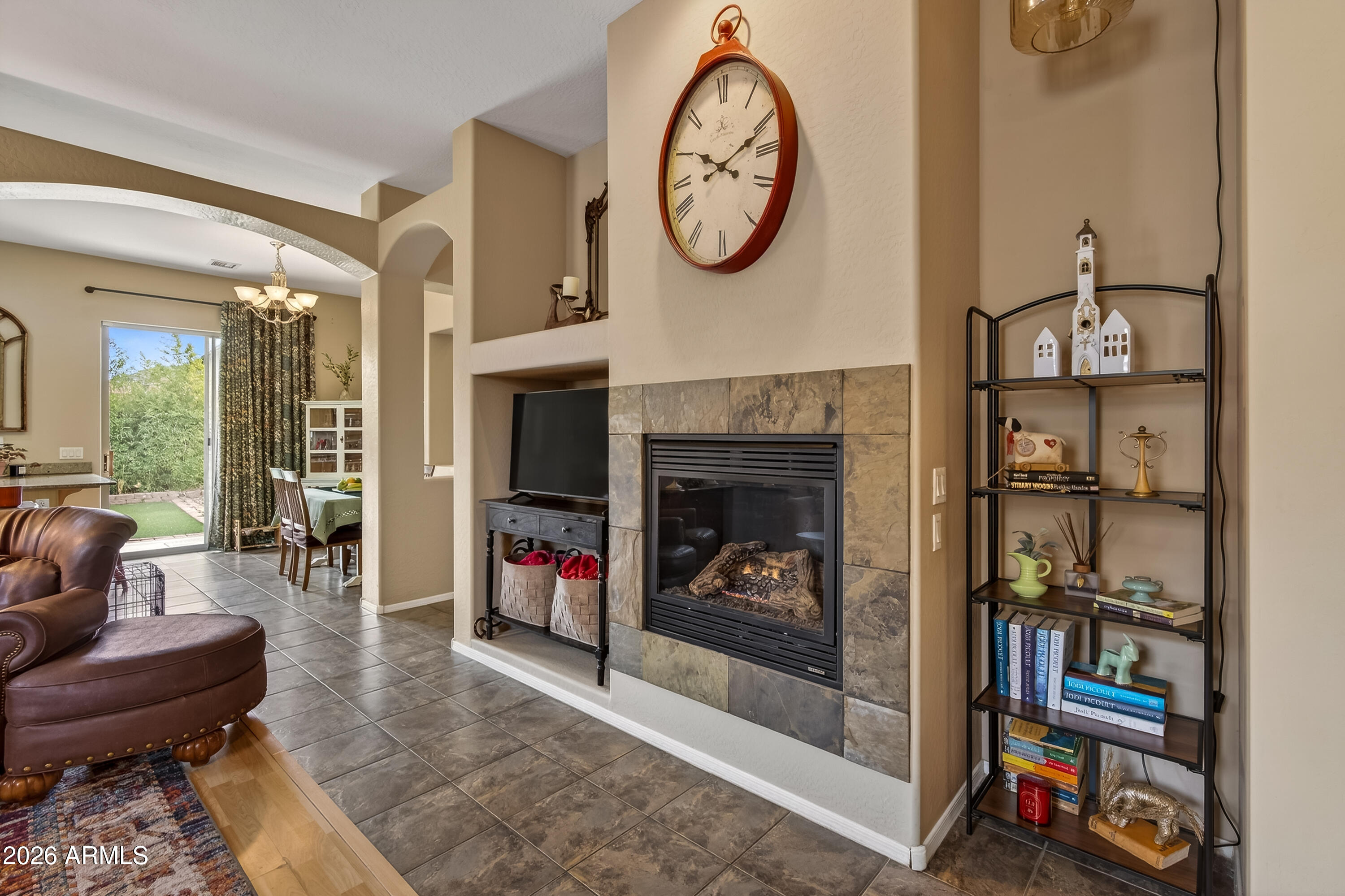 654 South Elk Ridge Drive Camp Verde, AZ 86322 - Photo 8 of 34 a living room with furniture a bookshelf and a fireplace