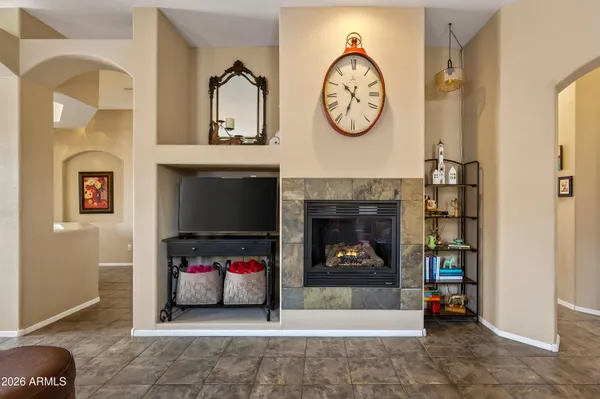 a living room with fireplace furniture and a fireplace