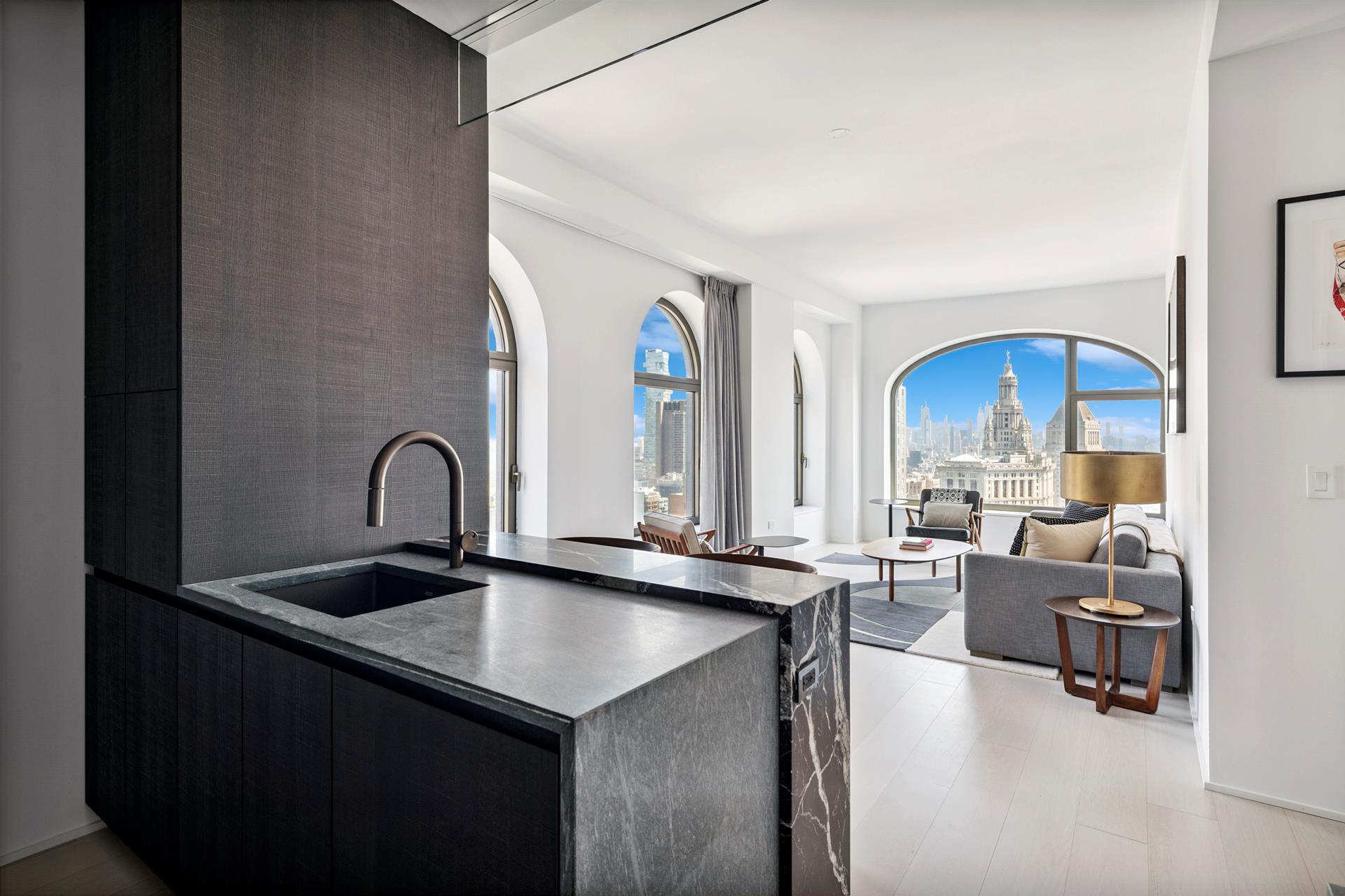 130 William Street, Unit 38A Manhattan, NY 10038 - Photo 2 of 12 a view of living room with granite countertop furniture and kitchen view