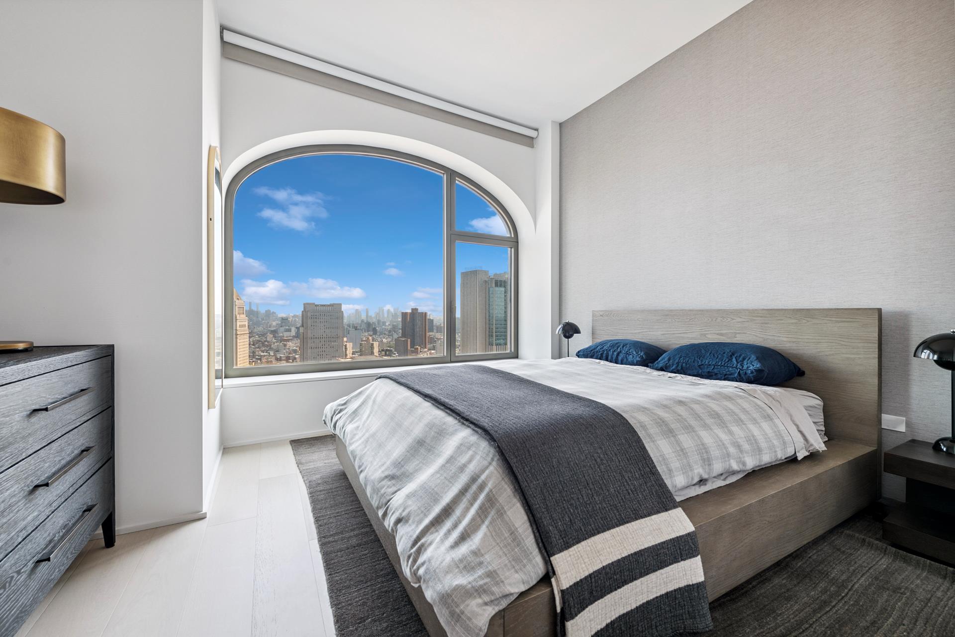 130 William Street, Unit 38A Manhattan, NY 10038 - Photo 5 of 12 a bedroom with a bed and a large window