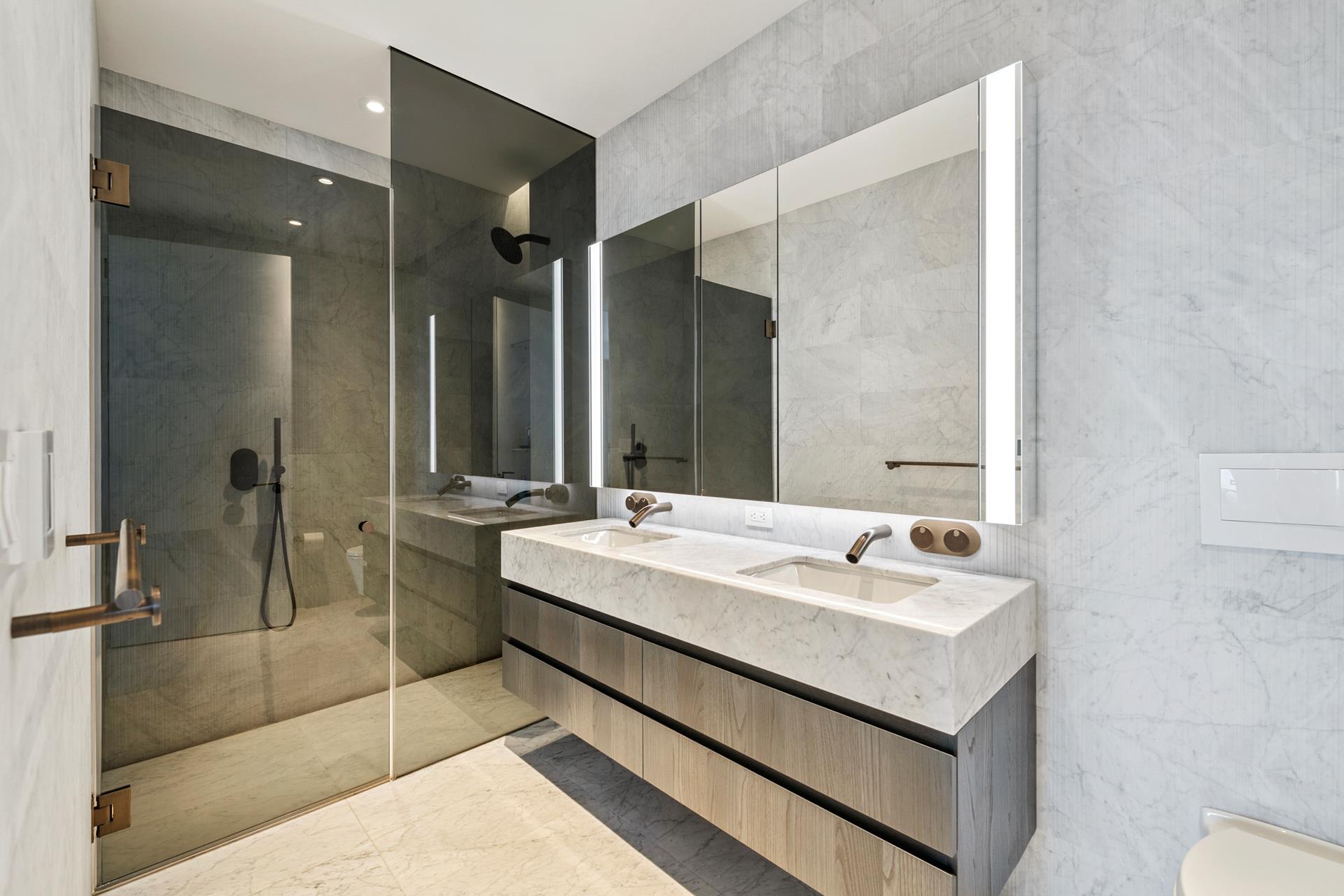 130 William Street, Unit 38A Manhattan, NY 10038 - Photo 6 of 12 a bathroom with a double vanity sink mirror and double