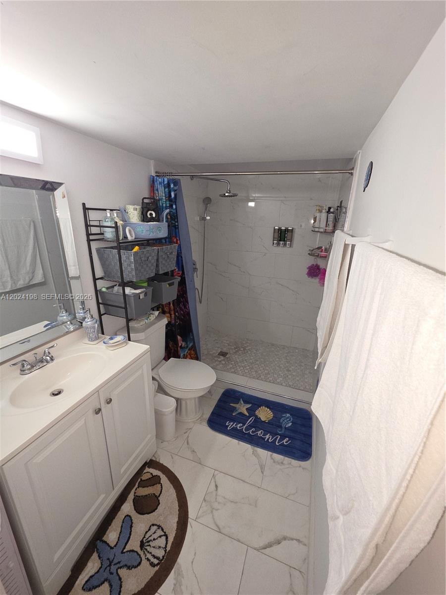 651 East 48th Street Hialeah, FL 33013 - Photo 10 of 52 a bathroom with a sink a toilet and shower