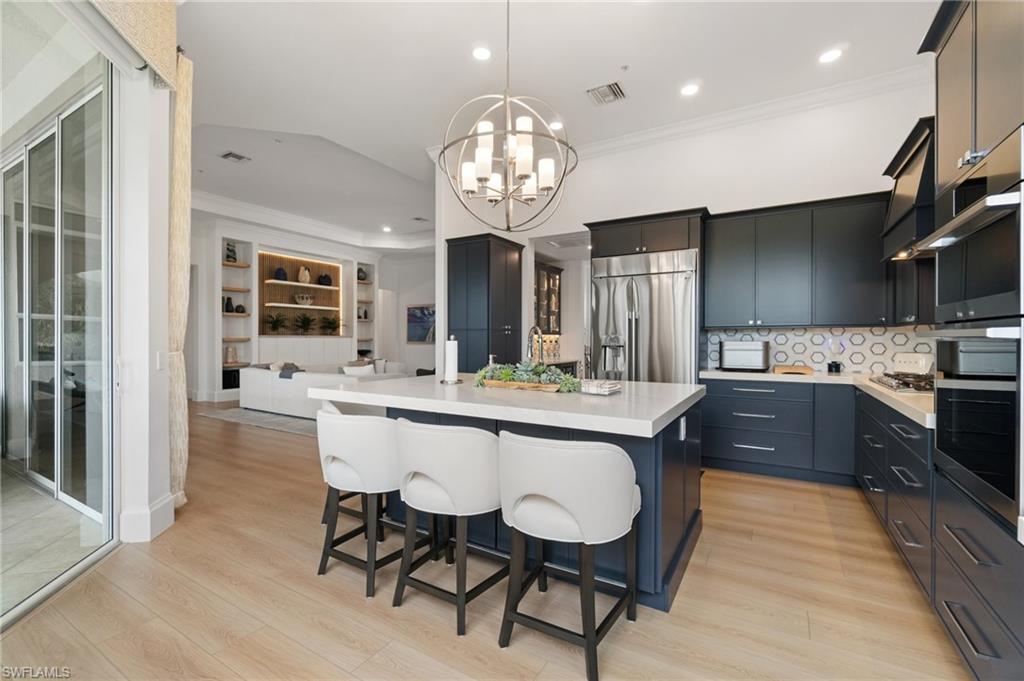 17010 Porta Vecchio Way, Unit 201 Naples, FL 34110 - Photo 1 of 50 a large kitchen with granite countertop lots of counter space and breakfast area