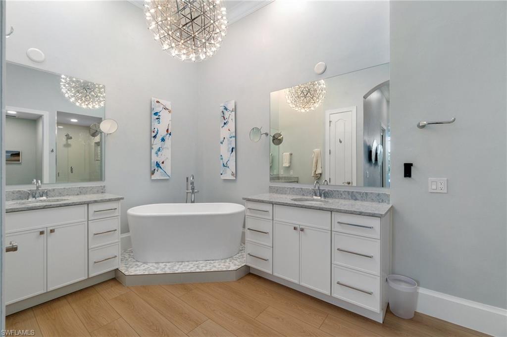 17010 Porta Vecchio Way, Unit 201 Naples, FL 34110 - Photo 14 of 50 a spacious bathroom with a granite countertop sink a large mirror and a bathtub
