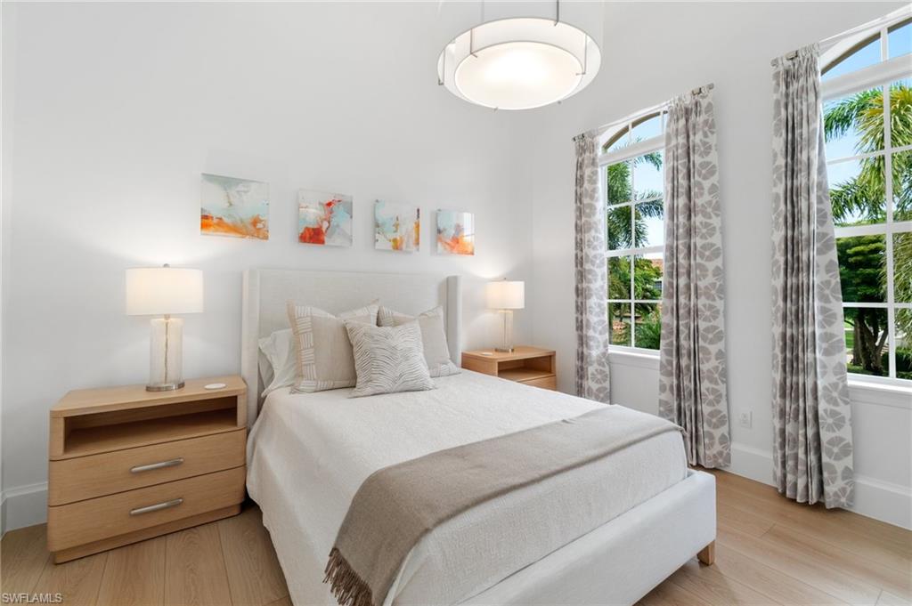 17010 Porta Vecchio Way, Unit 201 Naples, FL 34110 - Photo 17 of 50 a bedroom with a bed and a window