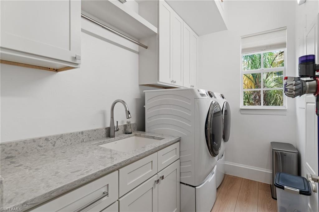 17010 Porta Vecchio Way, Unit 201 Naples, FL 34110 - Photo 19 of 50 a close view of a sink and a washer in a room